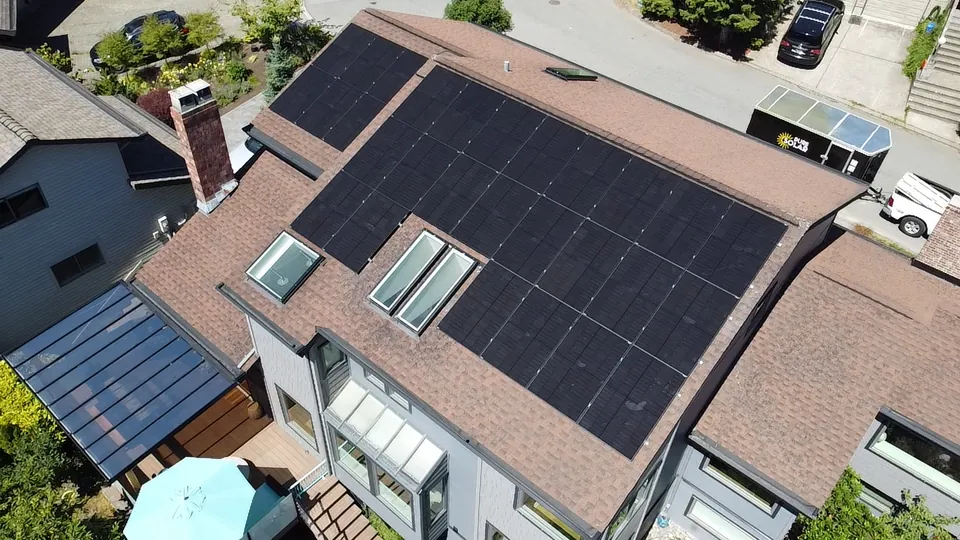 Aerial view of a solar array on the shingle roof of a Lower Mainland family home