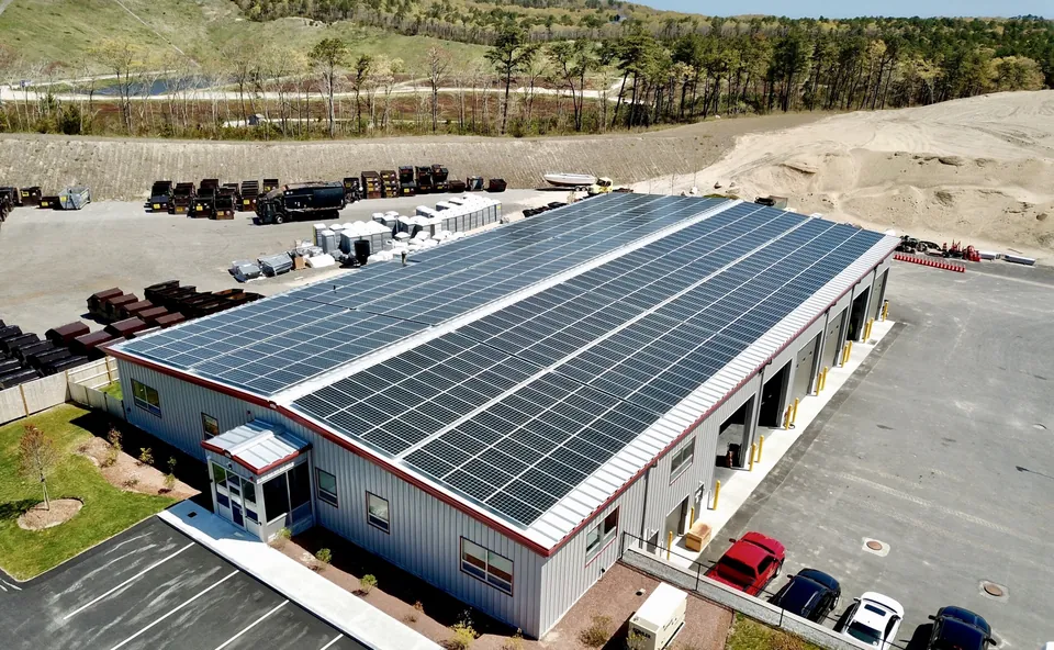 Commercial solar array across the long metal roof of an industrial building in British Columbia