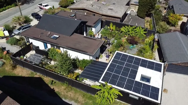 Solar panels on a flat roof section of a home in a leafy Lower Mainland neighbourhood